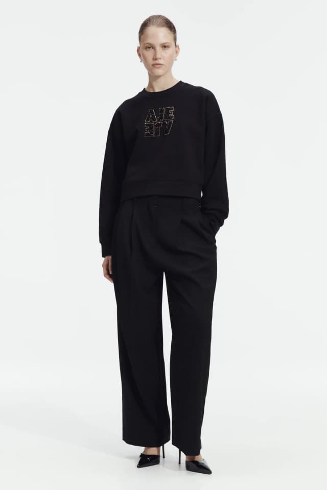 AJE Amina Logo Sweater in BLACK, image 1 of 1 from Aje