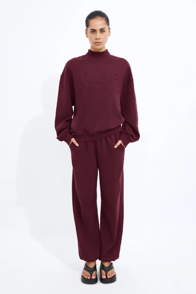 Athletica Cuffed Hem Logo Track Pants in BURGUNDY, image 1 of 1 from Aje