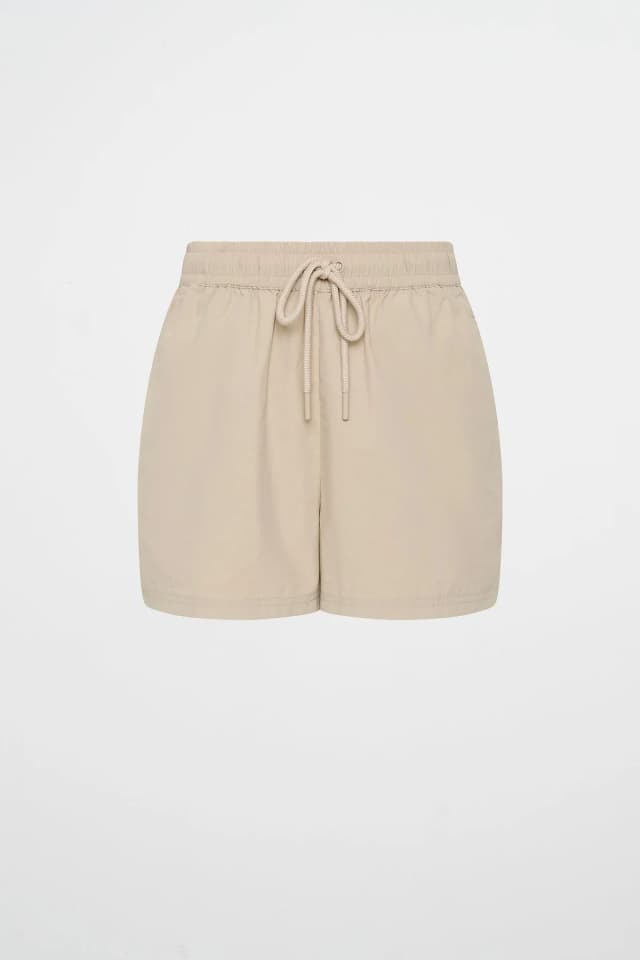 Athletica Drawstring Spray Short 608 in MACADAMIA, image 1 of 1 from Aje
