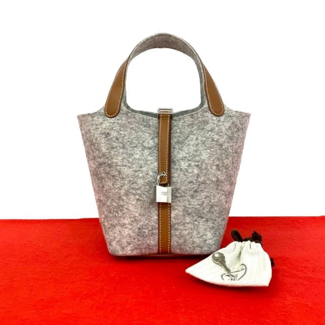 Hermès With Key Picotin Lock PM Felt Swift Leather Handbag Gripaire Gold in Gold Swift leather from The Reluxe, photo 1 of 1